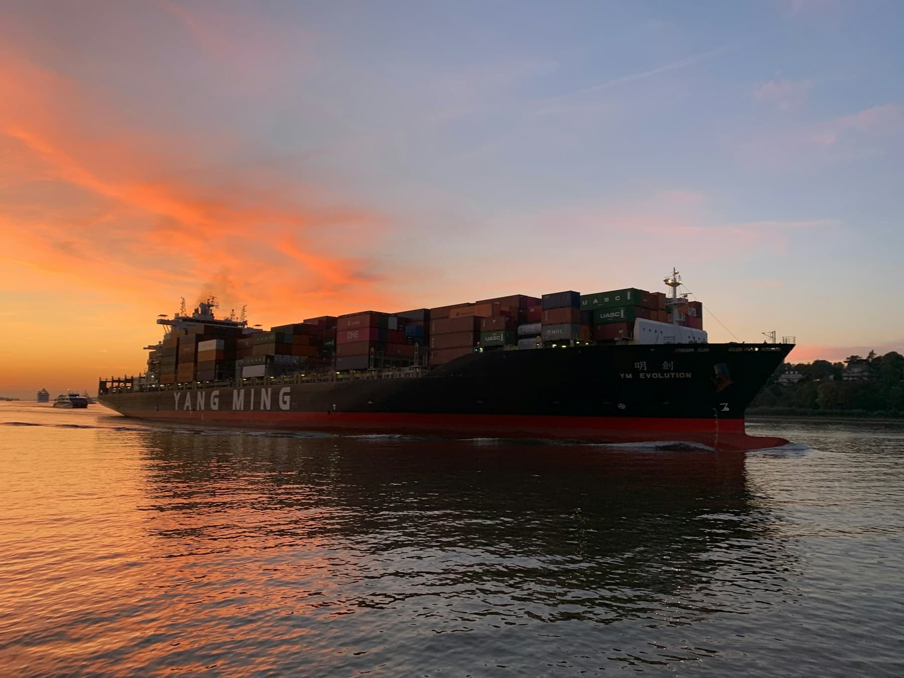 Container ship at sea during sunset